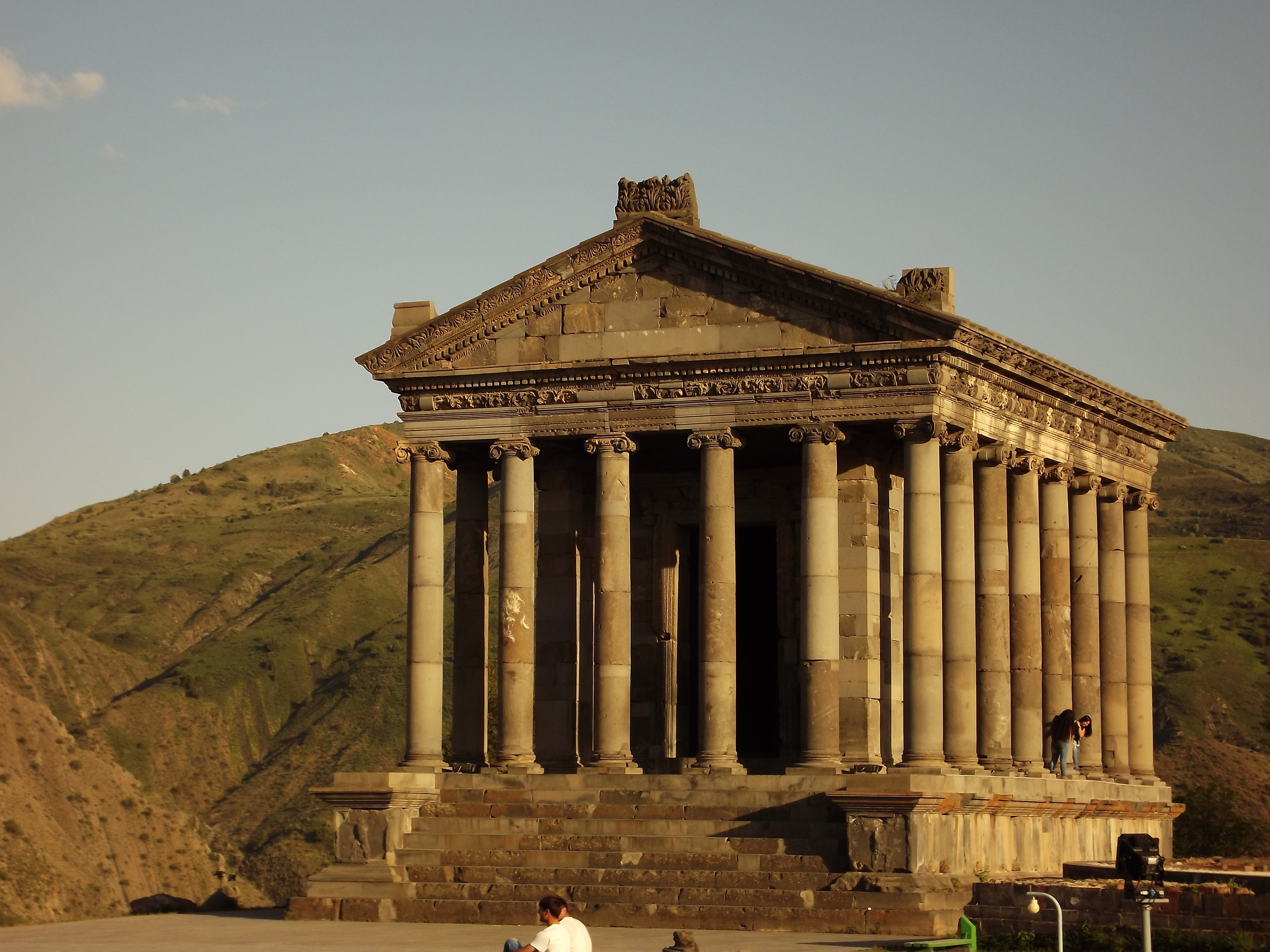 Garni temple with columns against a mountainous landscape
